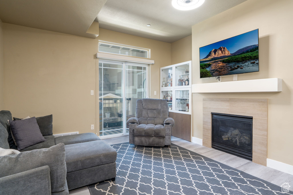 Living area featuring wood finished floors and a tile fireplace