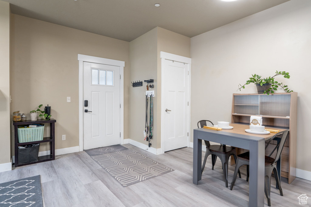 Entrance foyer with light wood finished floors and baseboards
