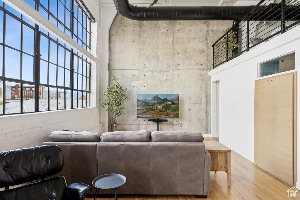 Living area with a high ceiling and wood finished floors