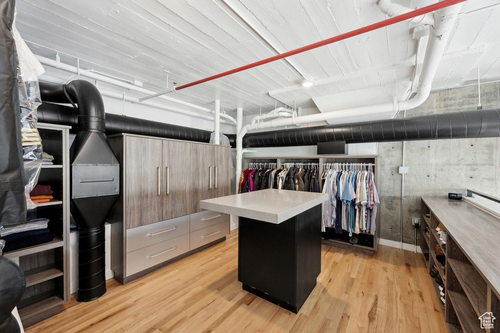 Spacious closet with light wood-style flooring