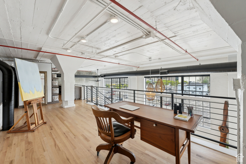 Office area with healthy amount of natural light and wood finished floors