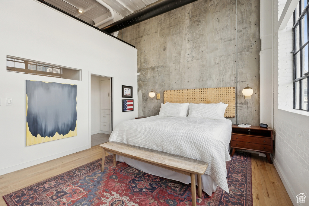 Bedroom with wood finished floors and baseboards