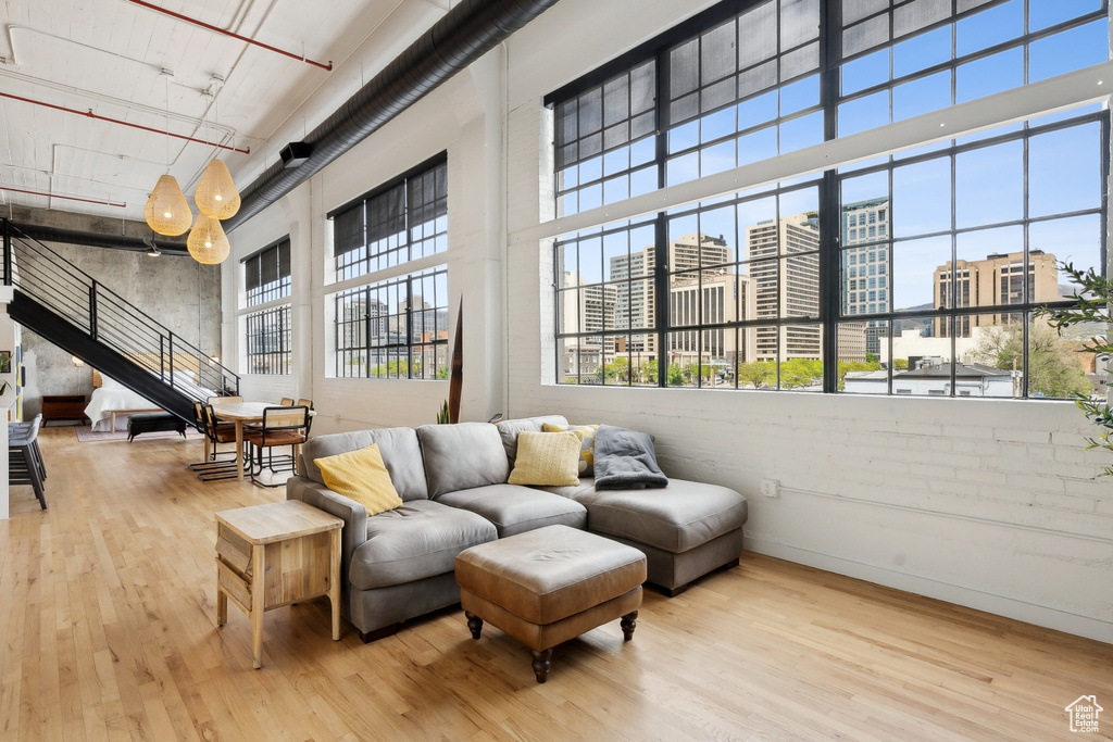 Community lobby featuring a towering ceiling, a city view, and stairs