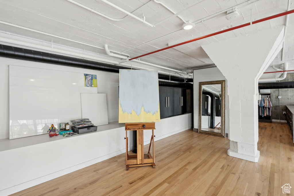 Basement with wood finished floors and baseboards