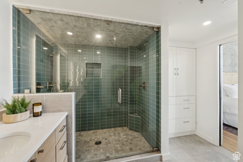Full bathroom featuring a shower stall, ensuite bathroom, recessed lighting, vanity, and tile patterned flooring