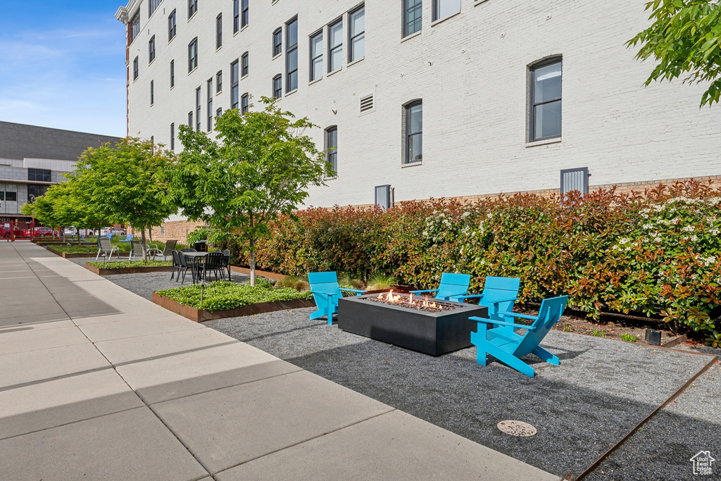 Surrounding community with a fire pit and a patio area