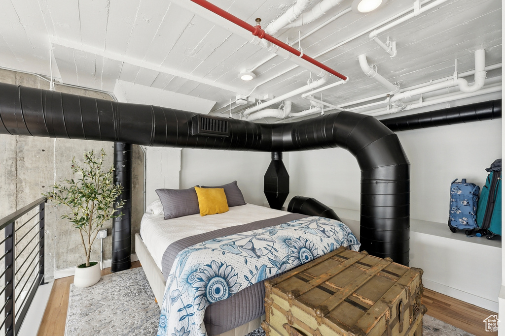 Bedroom featuring wood finished floors and baseboards
