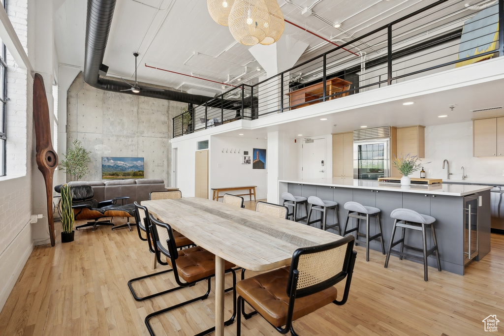 Dining space with a high ceiling and light wood-style flooring