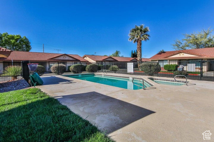 Community pool featuring a patio and a hot tub