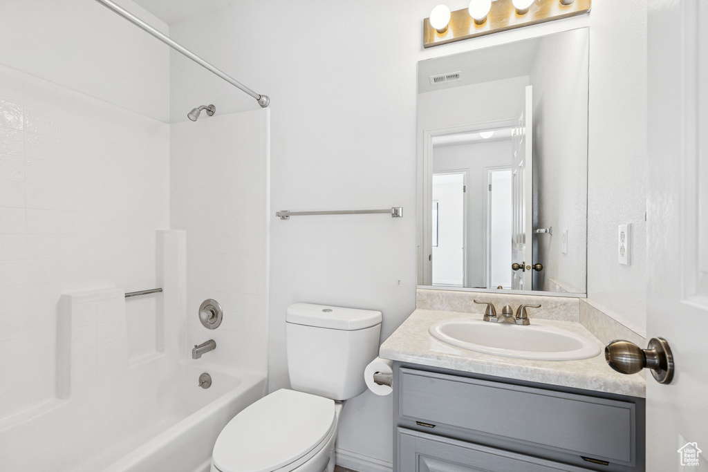 Bathroom with vanity, toilet, and shower / bath combination
