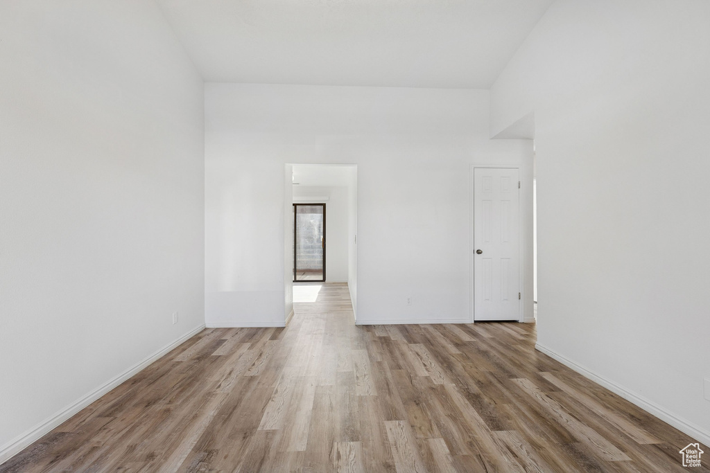 Empty room with light wood finished floors and baseboards