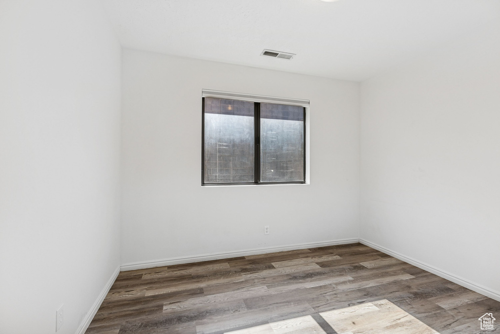 Spare room with wood finished floors and baseboards