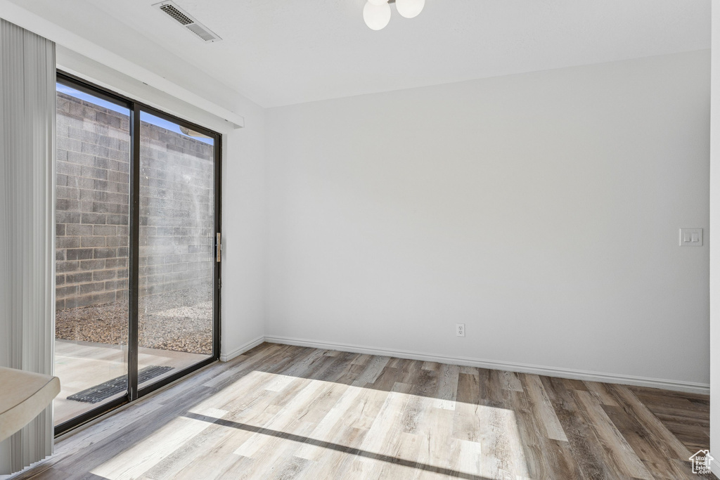 Unfurnished room featuring wood finished floors and baseboards