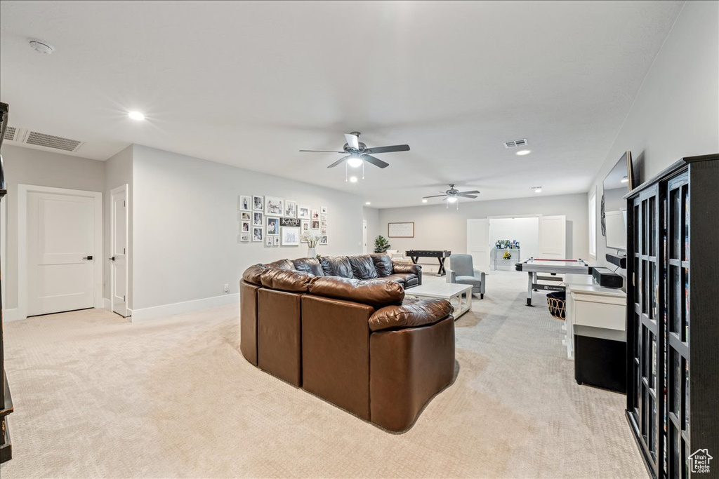 Living area with light colored carpet, recessed lighting, a ceiling fan, and baseboards