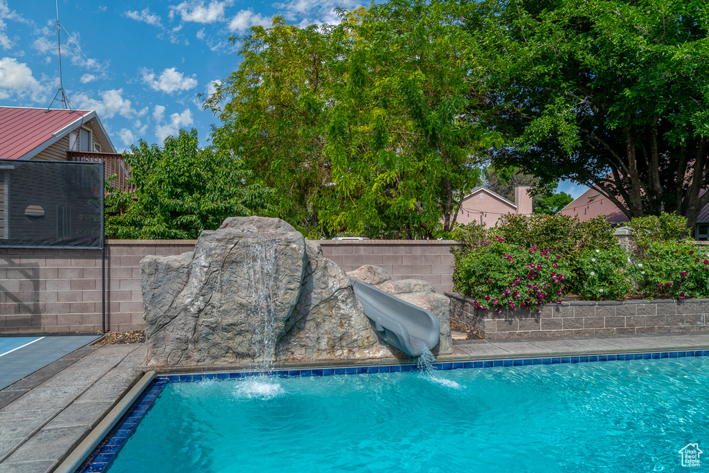 View of pool with a water slide
