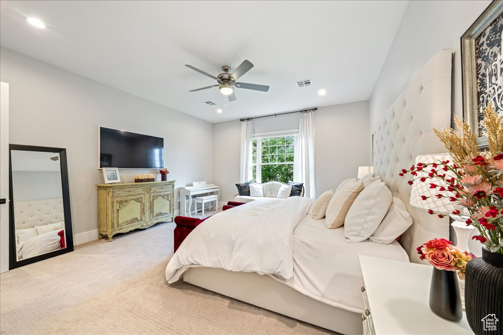 Bedroom with light carpet, recessed lighting, ceiling fan, and baseboards