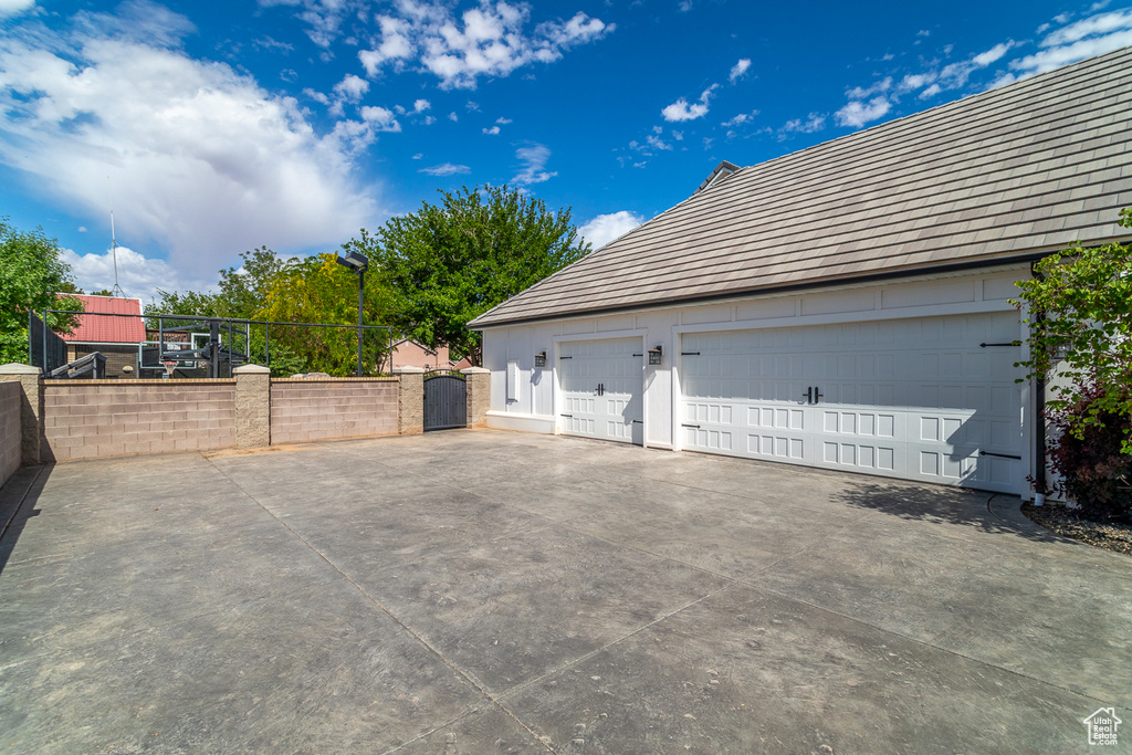 Garage featuring a gate and fence