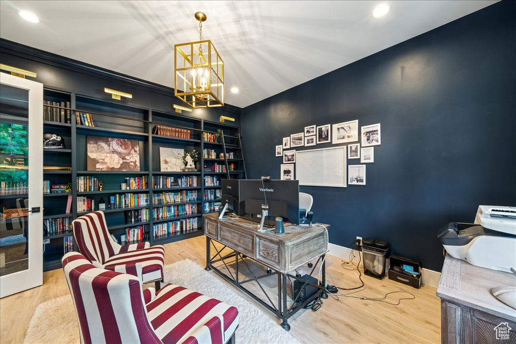 Office space featuring a chandelier, wood finished floors, and recessed lighting