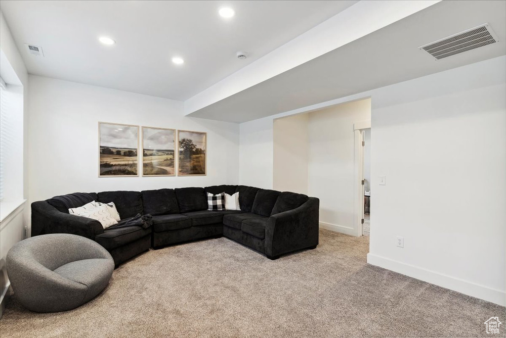 Living area featuring light colored carpet, recessed lighting, and baseboards