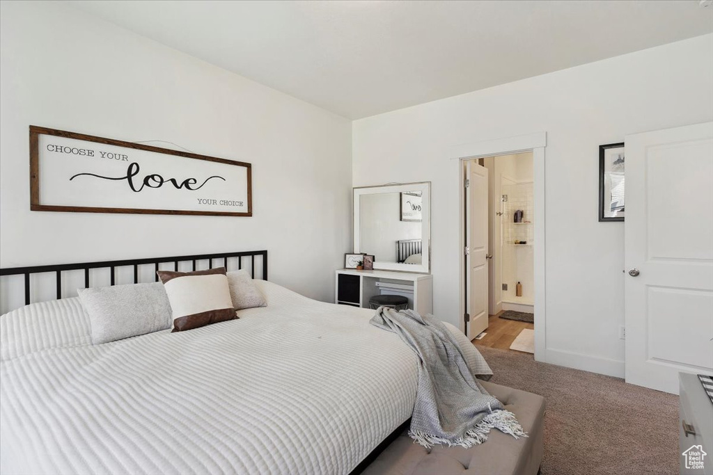 Carpeted bedroom with ensuite bathroom
