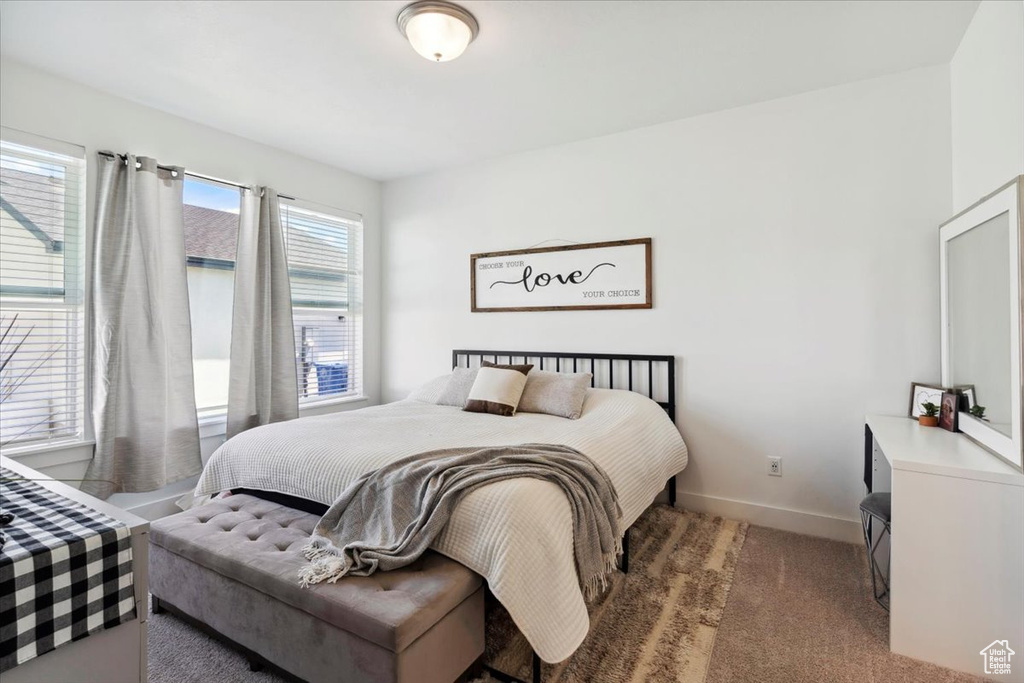 Bedroom featuring carpet flooring and baseboards