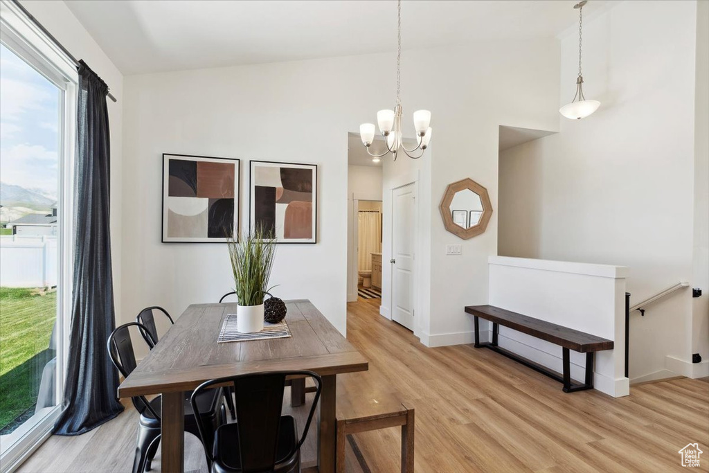 Dining room featuring a chandelier, light wood-style floors, and baseboards
