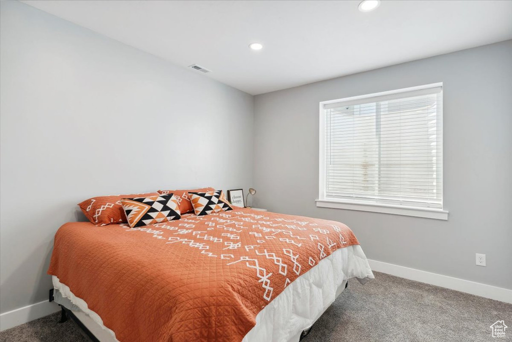 Bedroom with carpet, baseboards, and recessed lighting