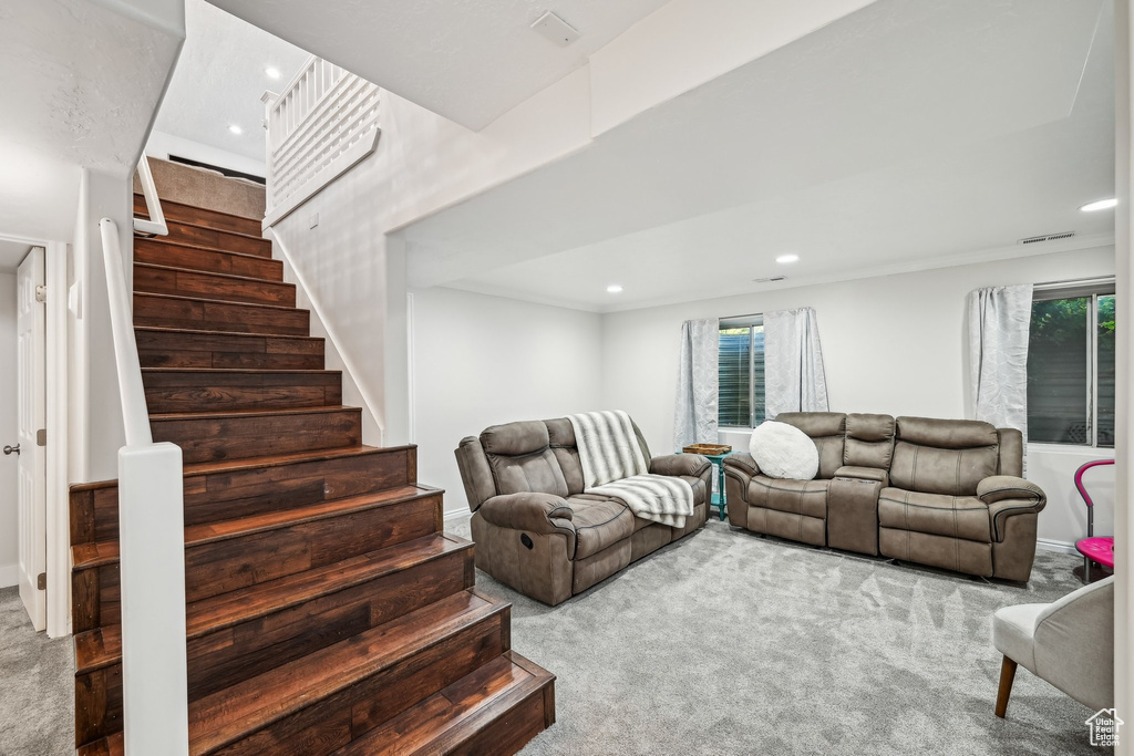 Carpeted living area with stairway, recessed lighting, and baseboards