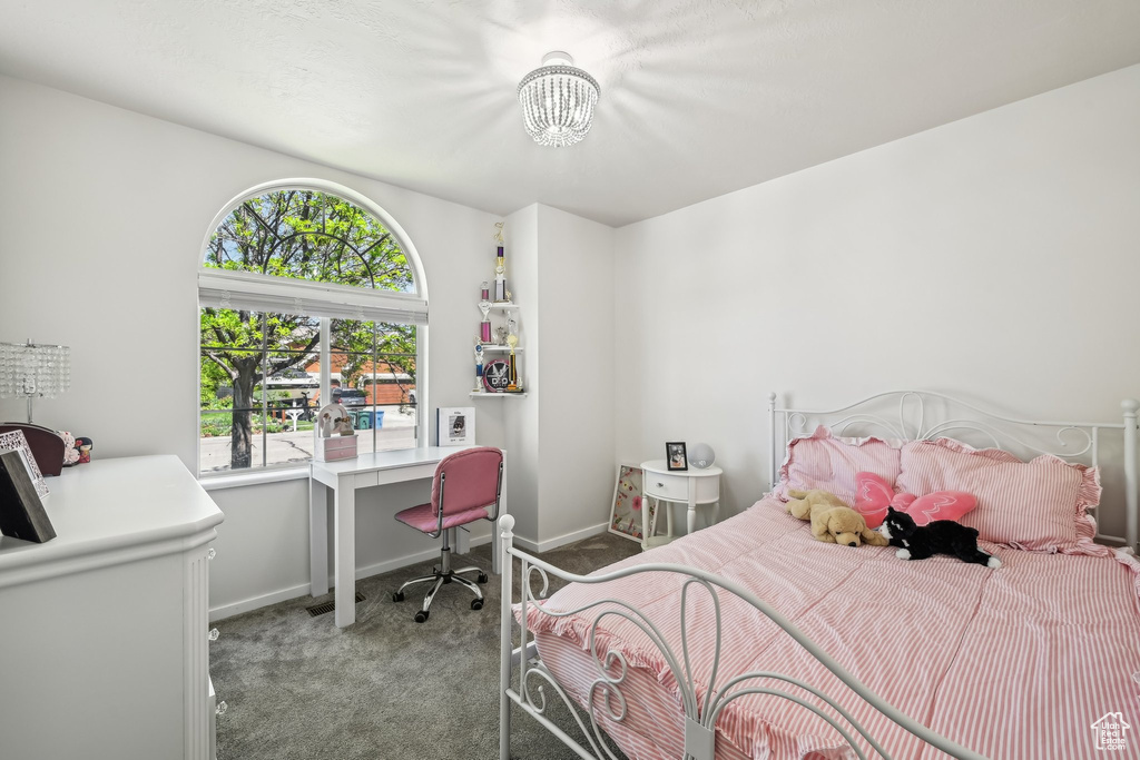 Bedroom featuring carpet, a chandelier, an office area, and baseboards