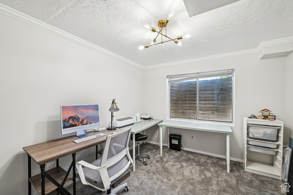 Carpeted office featuring a chandelier, ornamental molding, baseboards, and a textured ceiling