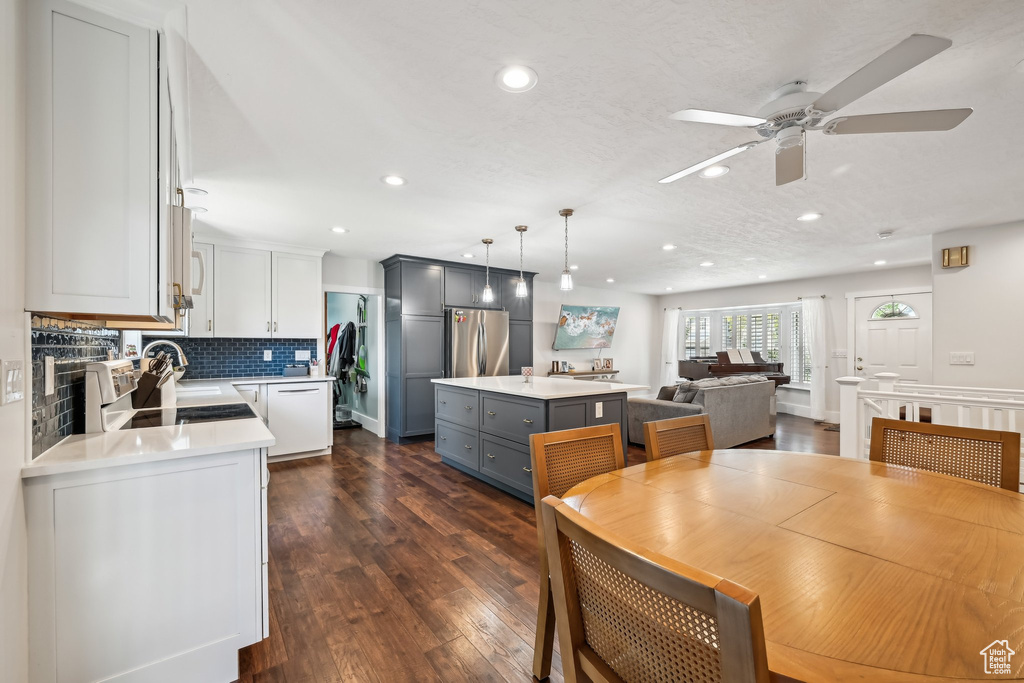 Dining room featuring ceiling fan, recessed lighting, and dark wood finished floors