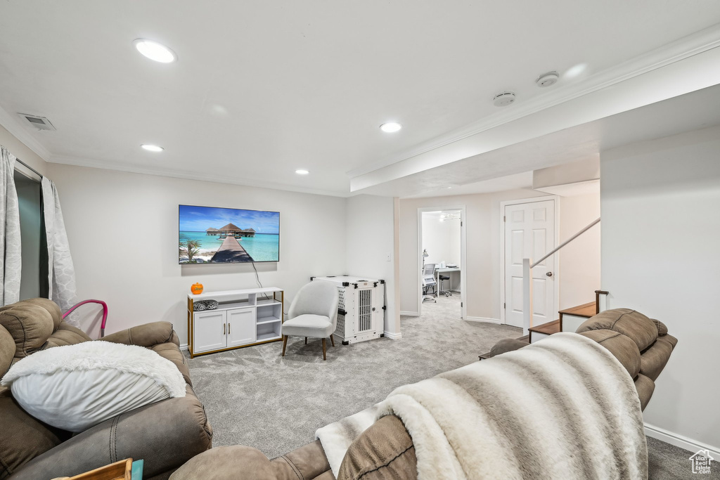 Carpeted living room with recessed lighting, crown molding, baseboards, and stairway