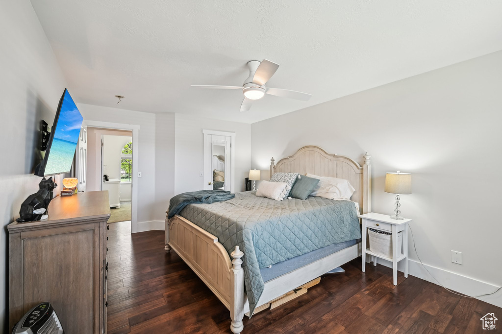 Bedroom featuring baseboards, wood finished floors, and a ceiling fan