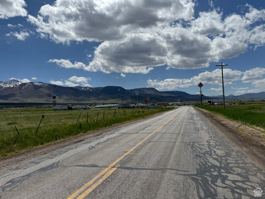 View of asphalt street with a mountain view and a view of rural / pastoral area