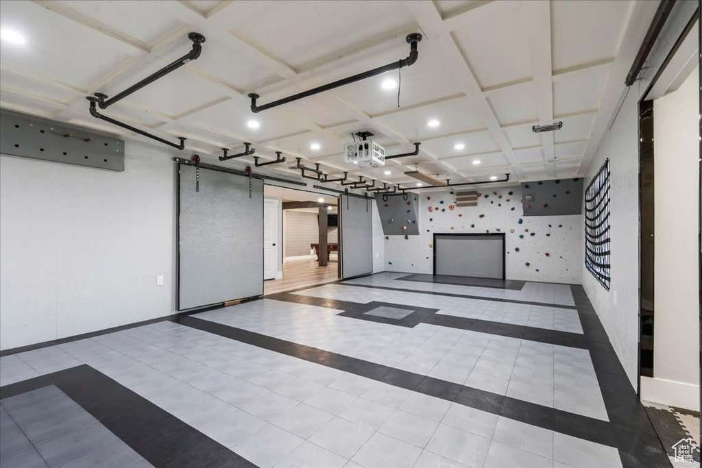 Garage featuring recessed lighting, baseboards, and wallpapered walls