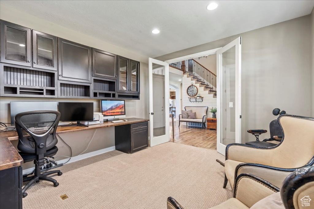 Office featuring built in study area, recessed lighting, light carpet, and french doors