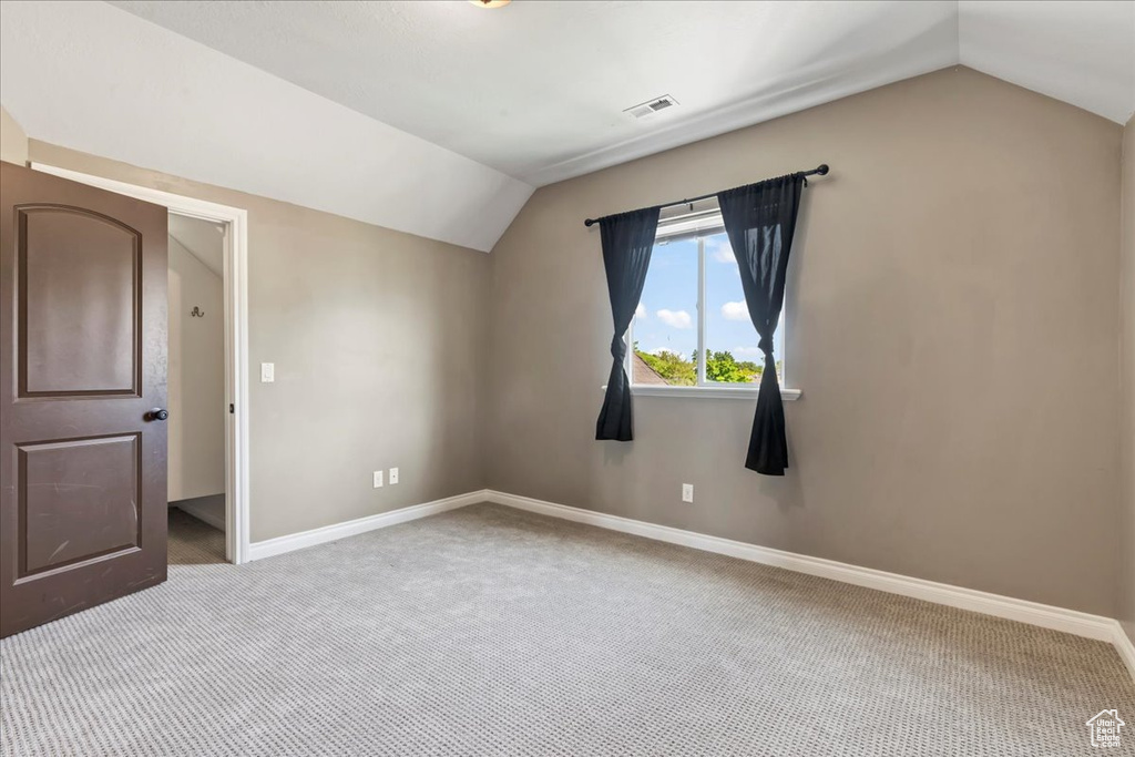 Bonus room with vaulted ceiling, carpet, and baseboards