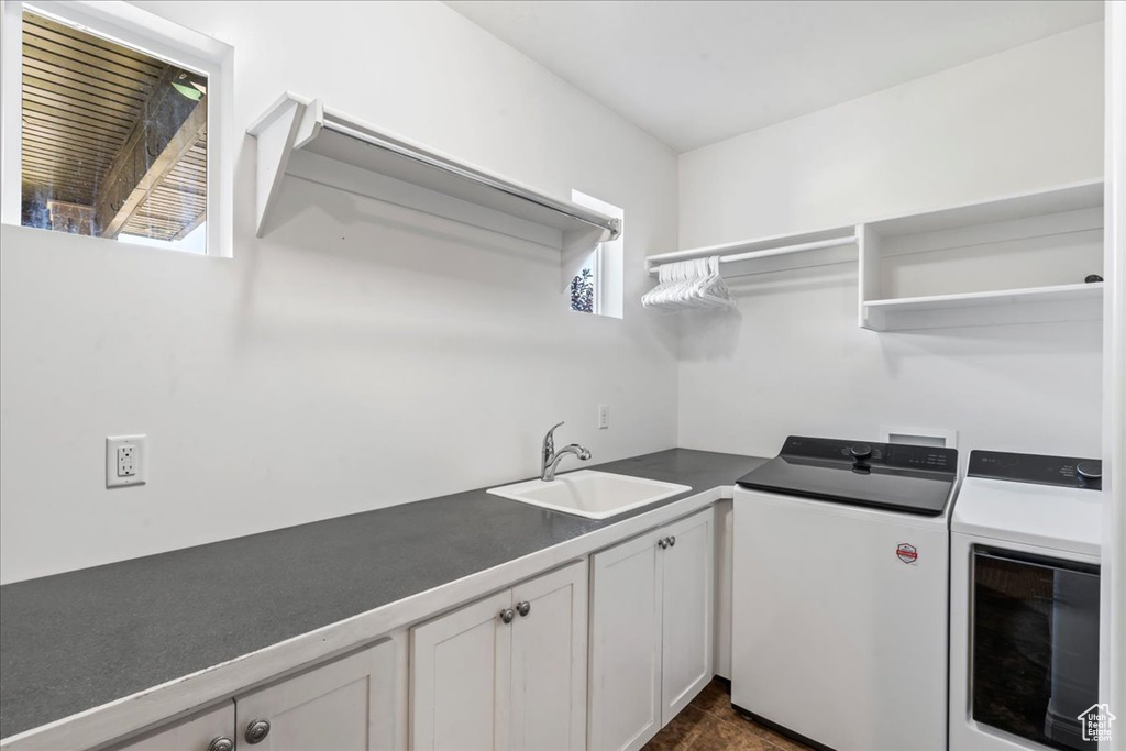 Washroom featuring washing machine and clothes dryer and cabinet space