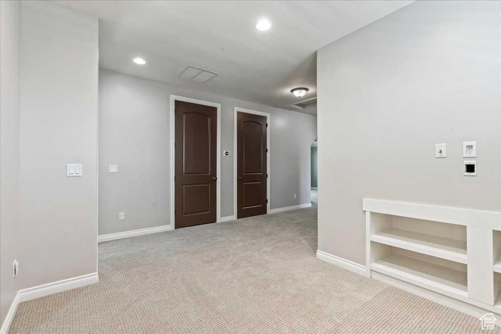 Spare room with carpet floors, baseboards, and recessed lighting