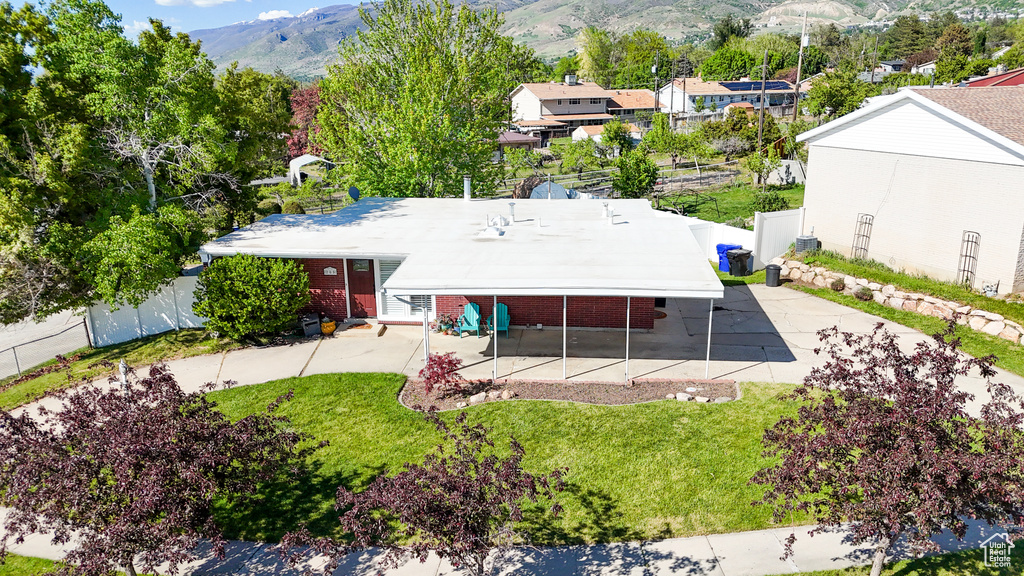 Aerial view of property and surrounding area featuring a mountainous background