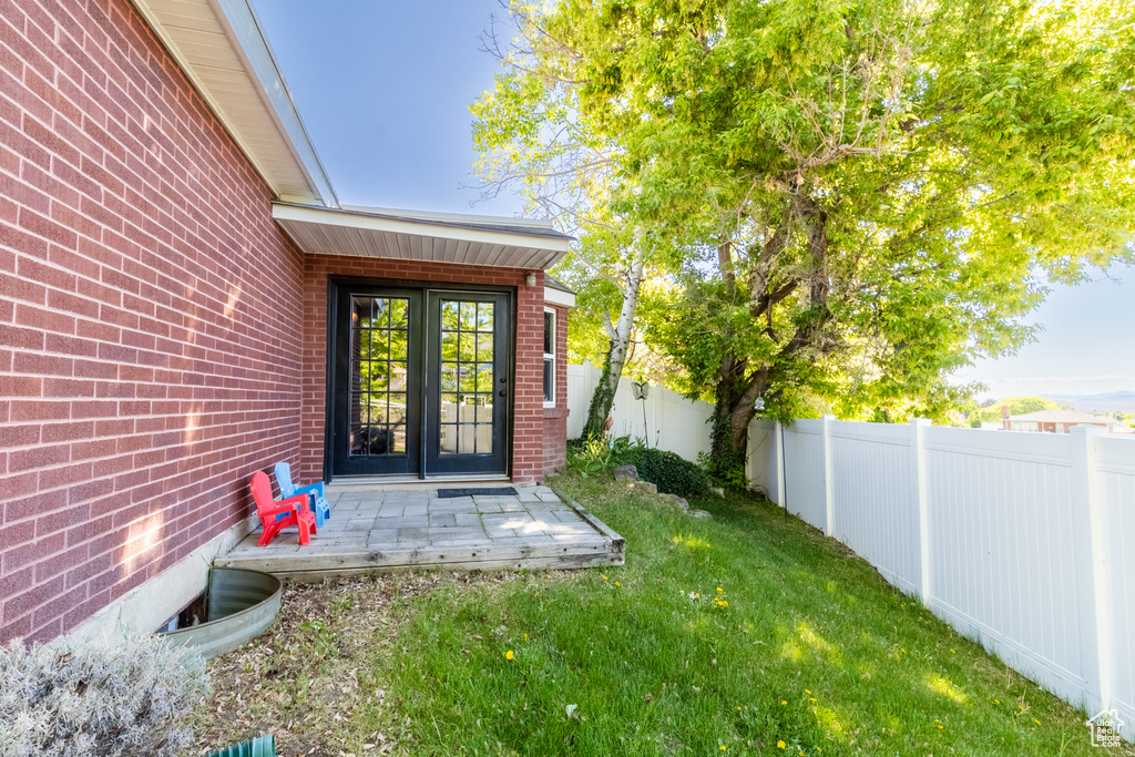 View of exterior entry with brick siding