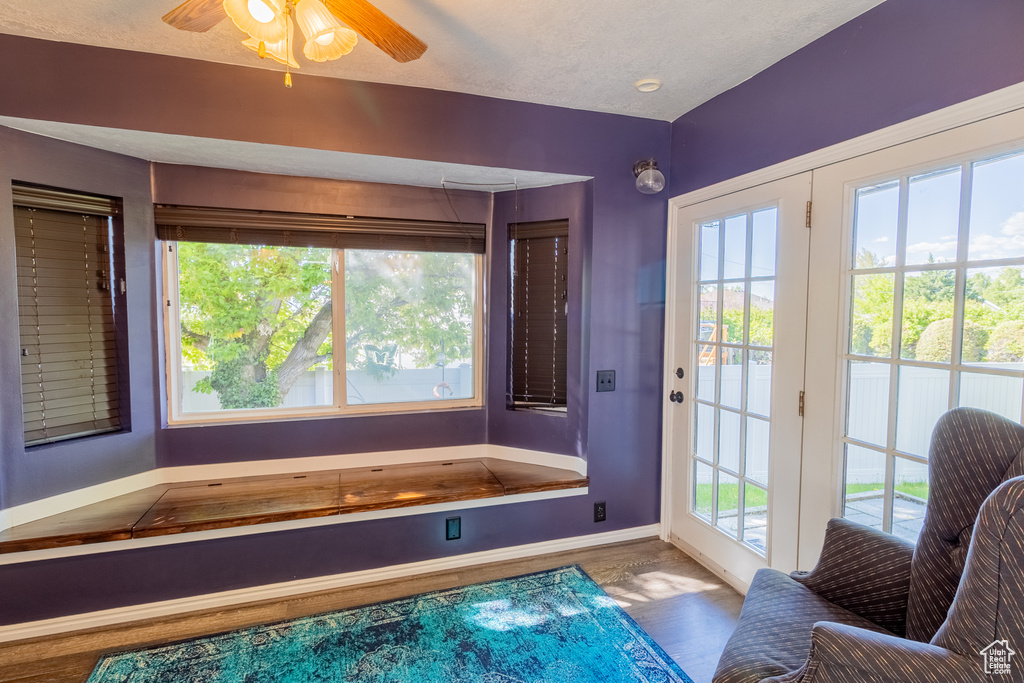 Bathroom featuring baseboards, healthy amount of natural light, and wood finished floors