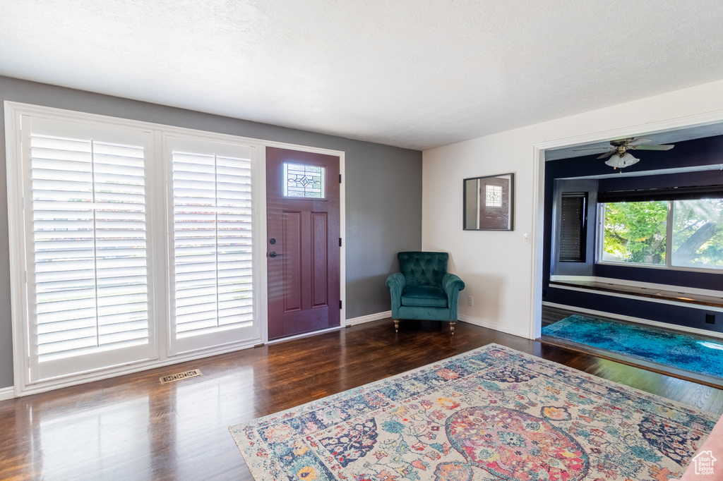 Foyer entrance with wood finished floors and baseboards