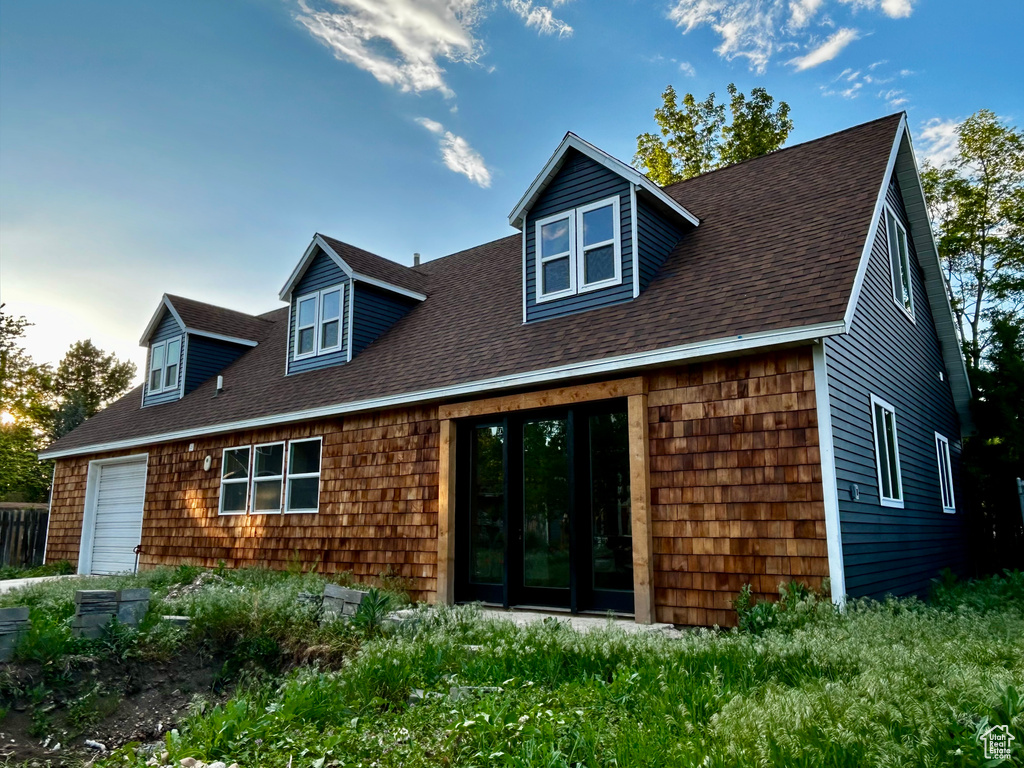 Rear view of house with a shingled roof