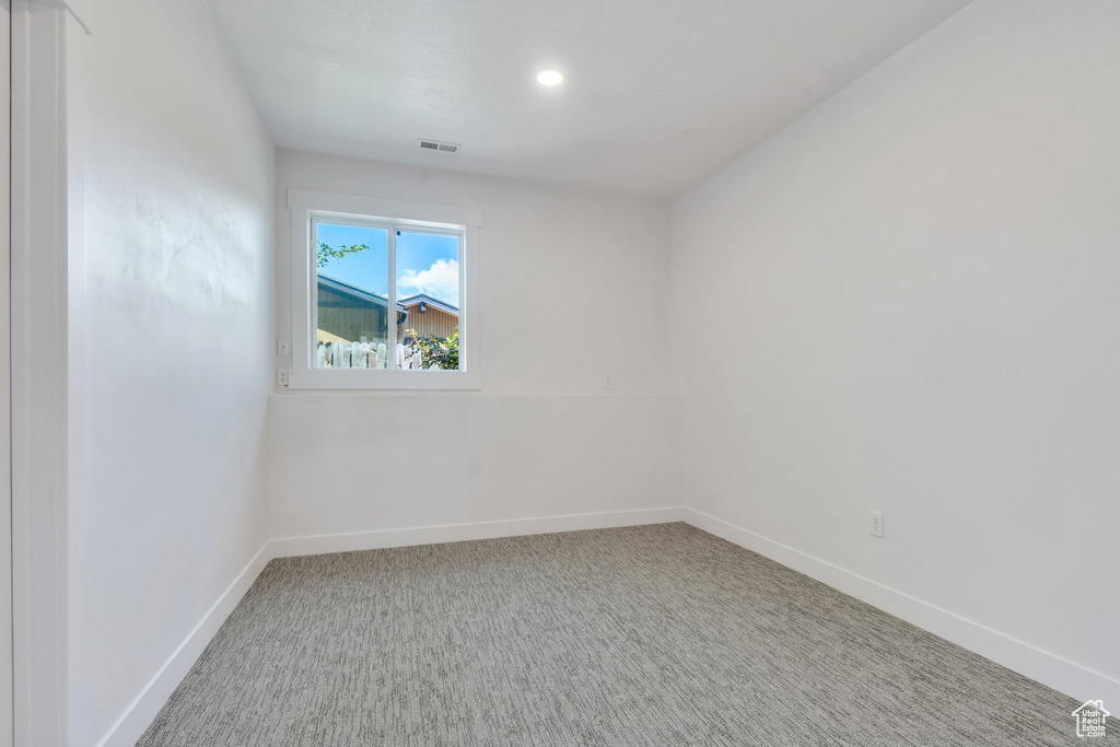Spare room featuring baseboards, carpet flooring, and recessed lighting