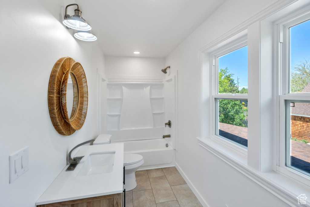 Bathroom featuring toilet, vanity, shower / tub combination, baseboards, and recessed lighting
