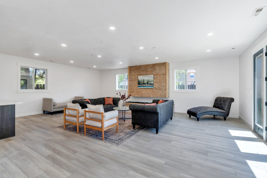 Living area with recessed lighting, baseboards, and light wood-type flooring