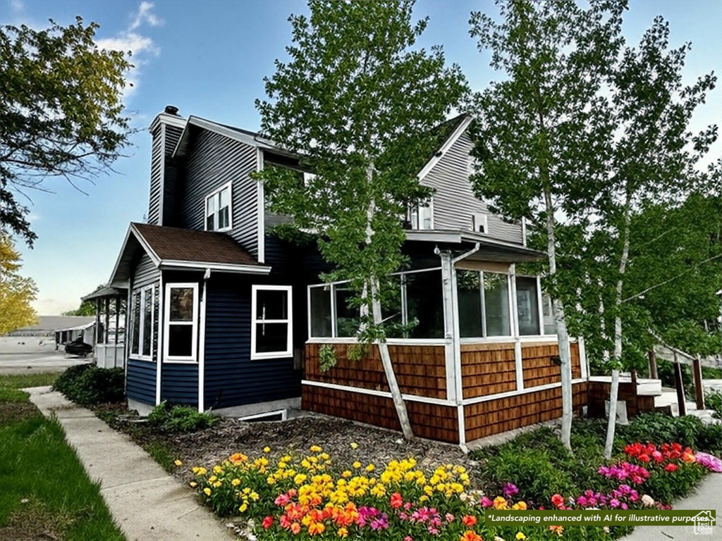 View of home\'s exterior with a sunroom and a chimney