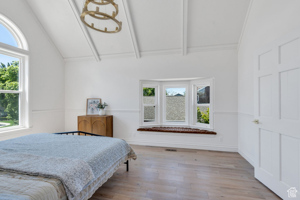 Bedroom featuring multiple windows and wood finished floors