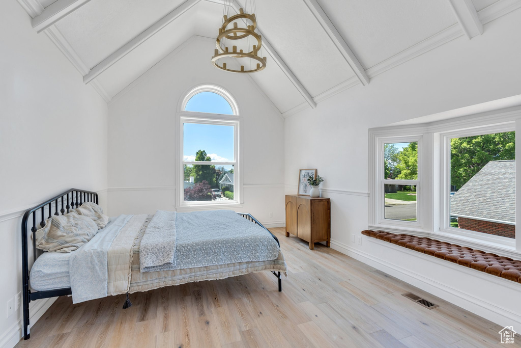 Bedroom with wood finished floors and baseboards